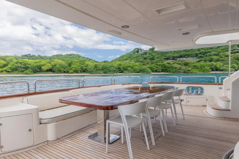 Slide: The Image of Luxury yacht Azimut 105 Grande 2006, featuring elegant outdoor dining area with scenic ocean view. - 25