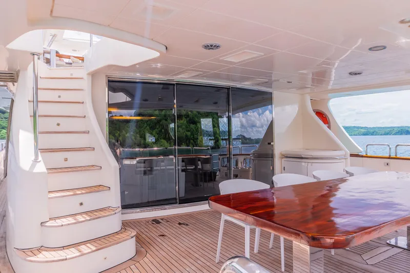 Slide: The Image of Luxurious 2006 Azimut 105 Grande yacht deck with elegant dining area and scenic ocean view. - 27