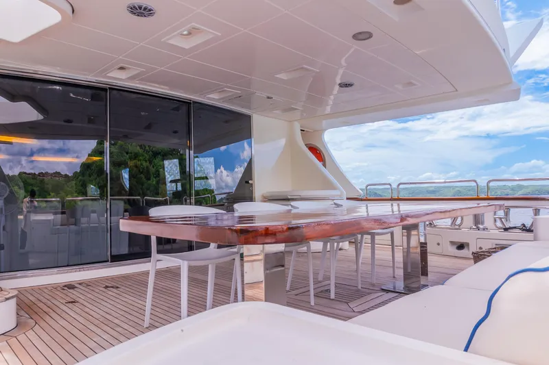 Slide: The Image of Luxurious outdoor deck of 2006 Azimut 105 Grande yacht with elegant dining area. - 28