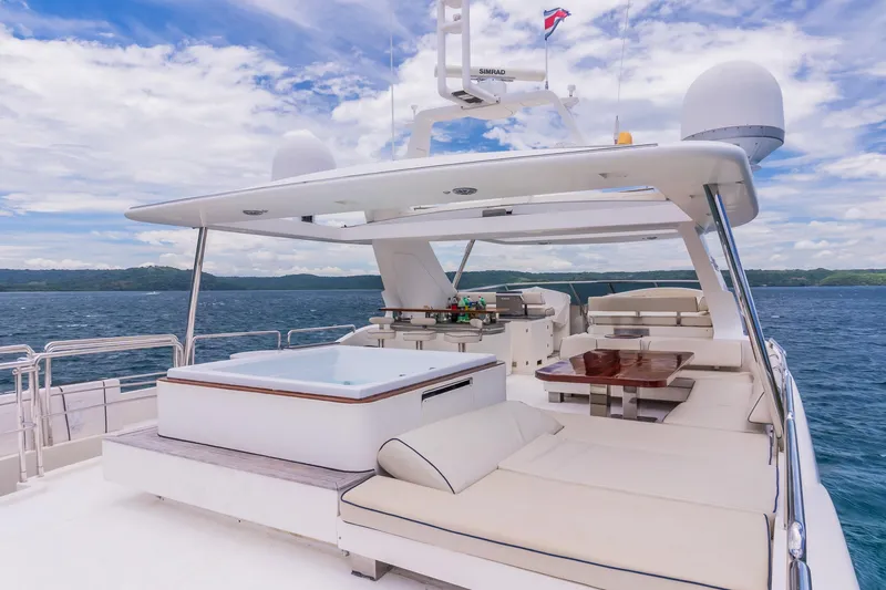 Slide: The Image of Luxurious 2006 Azimut 105 Grande yacht with spacious deck and seating, cruising on open water. - 32