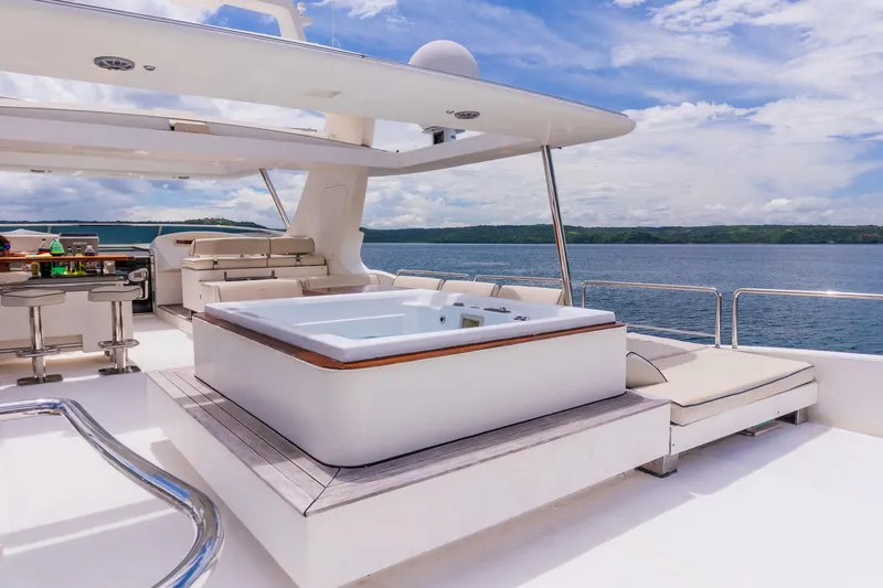 Slide: The Image of Luxurious Azimut 105 Grande yacht deck with jacuzzi, bar, and seating, 2006 model. - 33