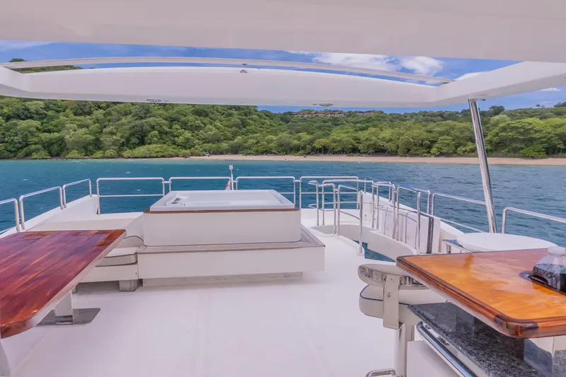 Slide: The Image of Luxurious Azimut 105 Grande yacht deck with ocean view, featuring seating and a jacuzzi, 2006 model. - 35