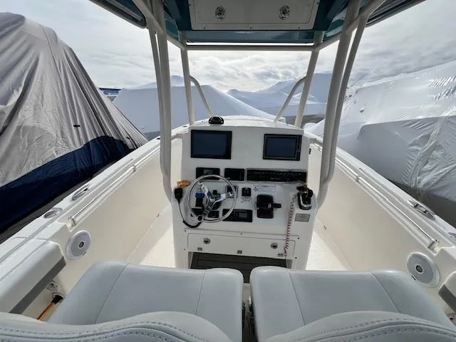 Slide: The Image of 2018 Cobia 277 Center Console boat interior with dual screens and steering wheel. - 2