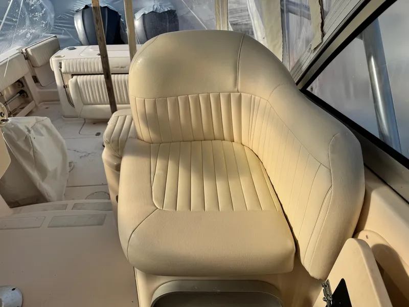 Slide: The Image of 2008 Grady-White Express 305 boat interior with beige seating and covered equipment. - 11