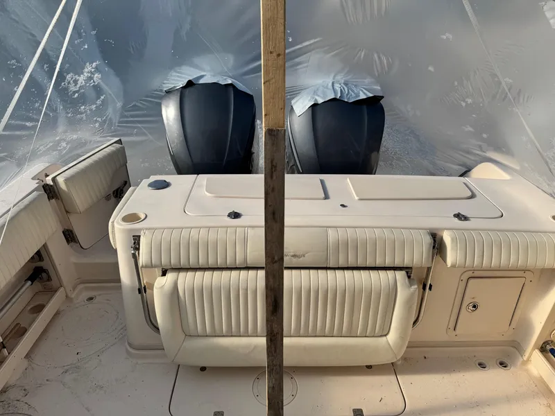 Slide: The Image of 2008 Grady-White Express 305 boat interior with twin engines, under protective cover. - 12