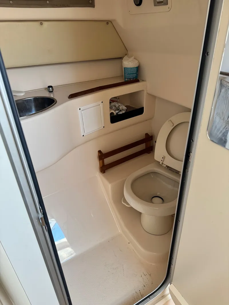 Slide: The Image of 2008 Grady-White Express 305 boat bathroom with toilet, sink, and storage. - 15