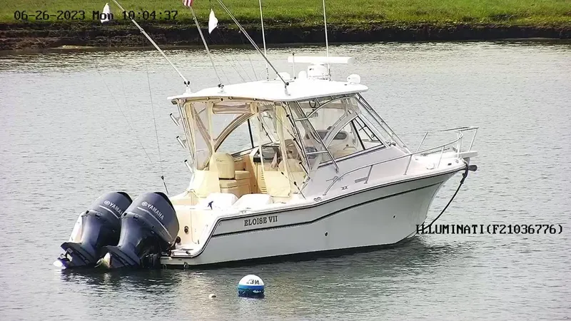 Slide: The Image of 2008 Grady-White Express 305 boat with twin Yamaha engines on calm water. - 5