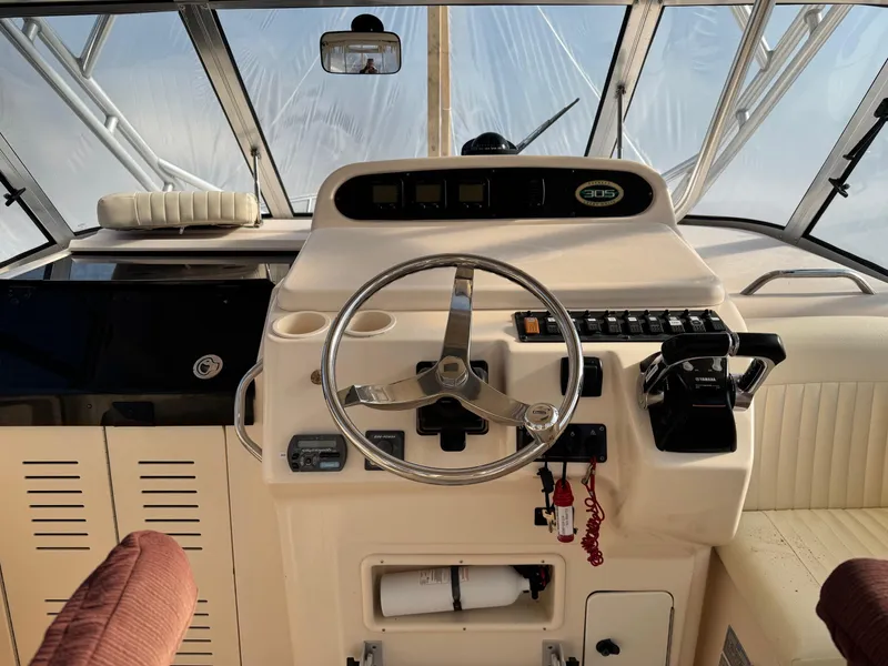Slide: The Image of 2008 Grady-White Express 305 boat helm with steering wheel and controls. - 8