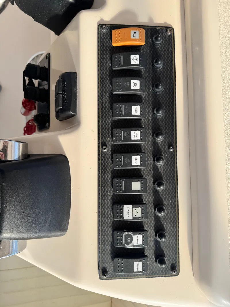 Slide: The Image of Control panel of a 2008 Grady-White Express 305 boat with labeled switches. - 9