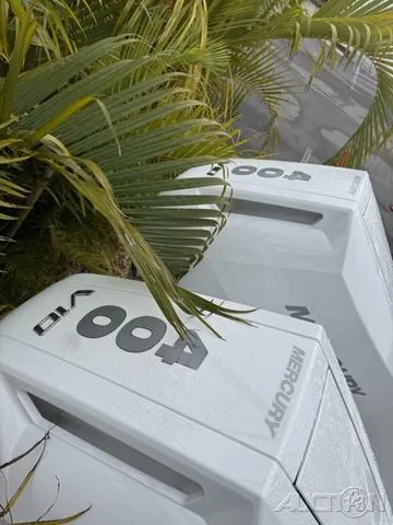 Slide: The Image of 2025 Blackfin 332cc boat with twin Mercury 400 engines, surrounded by tropical foliage. - 10