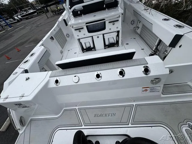 Slide: The Image of 2025 Blackfin 332cc boat interior with fishing rod holders and seating. - 11