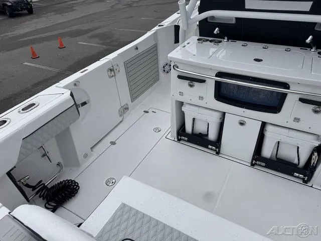 Slide: The Image of 2025 Blackfin 332cc boat interior with storage compartments and fishing equipment. - 14