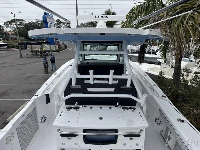 Slide: The Image of 2025 Blackfin 332cc boat with Garmin equipment, docked near palm trees. - 16