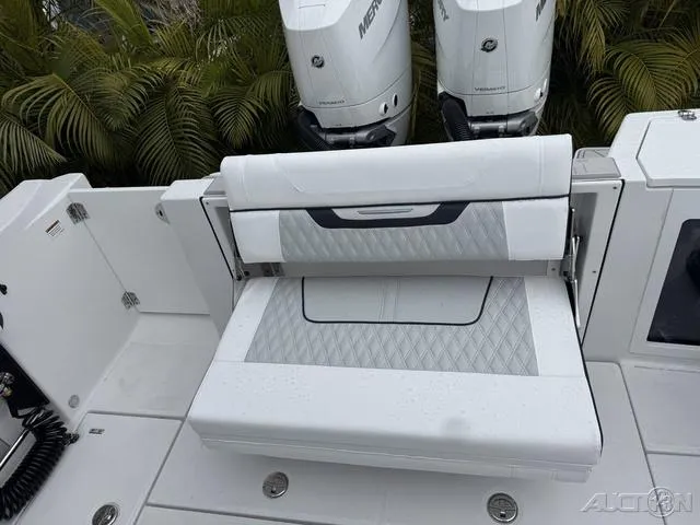 Slide: The Image of 2025 Blackfin 332cc boat with white seating and dual Mercury engines. - 19