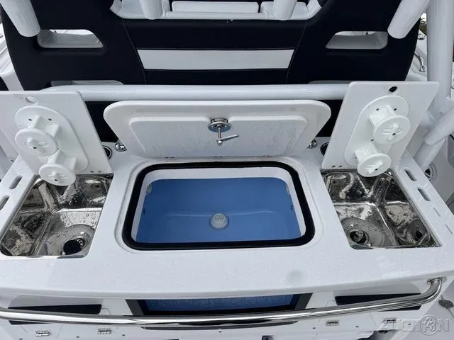 Slide: The Image of 2025 Blackfin 332cc boat with open storage compartments and fishing rod holders. - 20