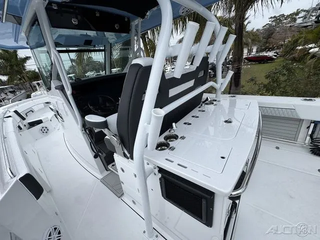 Slide: The Image of 2025 Blackfin 332cc boat interior with rod holders and seating, showcasing modern design and functionality. - 21