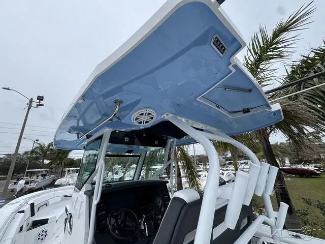 Slide: The Image of 2025 Blackfin 332cc boat with blue canopy and modern helm station. - 22