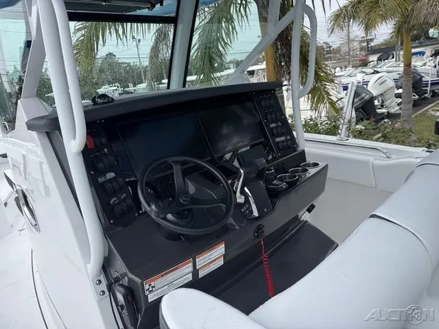 Slide: The Image of 2025 Blackfin 332cc boat cockpit with steering wheel and control panel. - 24