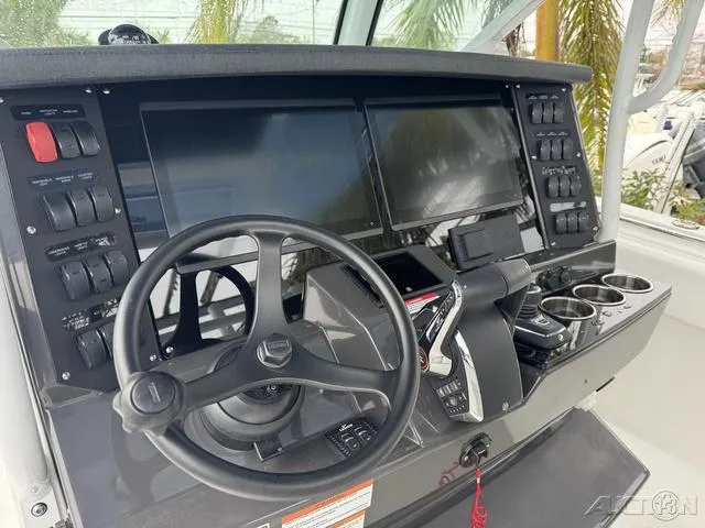 Slide: The Image of 2025 Blackfin 332cc boat dashboard with steering wheel and electronic controls. - 25