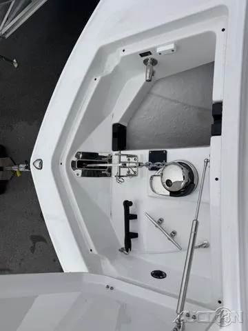 Slide: The Image of 2025 Blackfin 332cc boat anchor compartment with winch and storage features. - 29