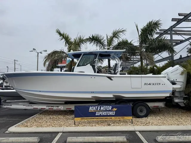 Slide: The Image of 2025 Blackfin 332cc boat displayed at dealership with palm trees in background. - 3