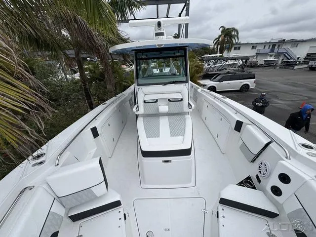 Slide: The Image of 2025 Blackfin 332cc boat, spacious deck, modern design, docked near palm trees. - 30