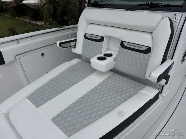 Slide: The Image of 2025 Blackfin 332cc boat interior with white and gray seating, featuring cup holders. - 35