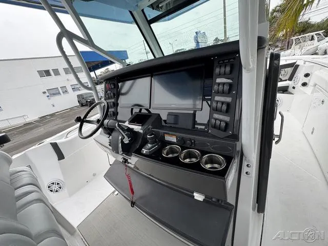 Slide: The Image of 2025 Blackfin 332cc boat cockpit with advanced navigation system and multiple cup holders. - 42