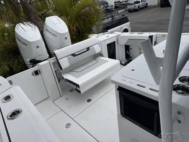 Slide: The Image of 2025 Blackfin 332cc boat interior with white seating and dual Mercury engines. - 44