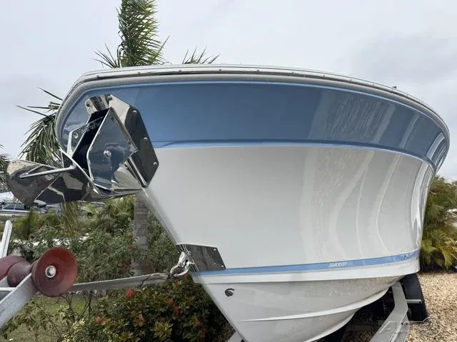 Slide: The Image of 2025 Blackfin 332cc boat with blue and white hull on a trailer. - 6