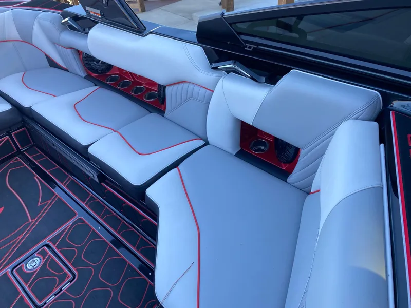 Slide: The Image of 2023 Centurion Fi23 interior with sleek gray and red upholstery, modern design, and spacious seating. - 12