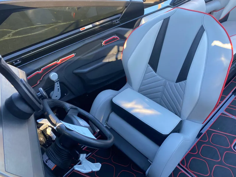 Slide: The Image of 2023 Centurion Fi23 boat interior with modern steering wheel and stylish seating design. - 13