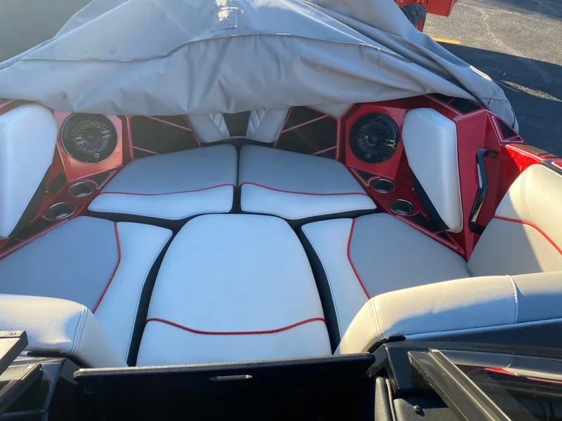 Slide: The Image of 2023 Centurion Fi23 boat interior with red and white seating and speaker system. - 14