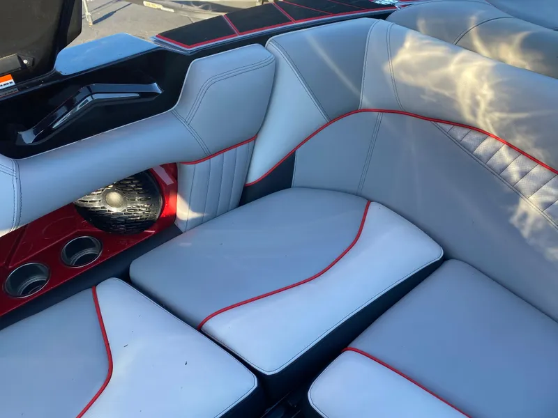Slide: The Image of 2023 Centurion Fi23 boat interior with gray and red seating, featuring modern design and speakers. - 4
