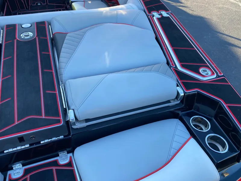Slide: The Image of 2023 Centurion Fi23 boat interior with sleek gray and red seating and cup holders. - 7