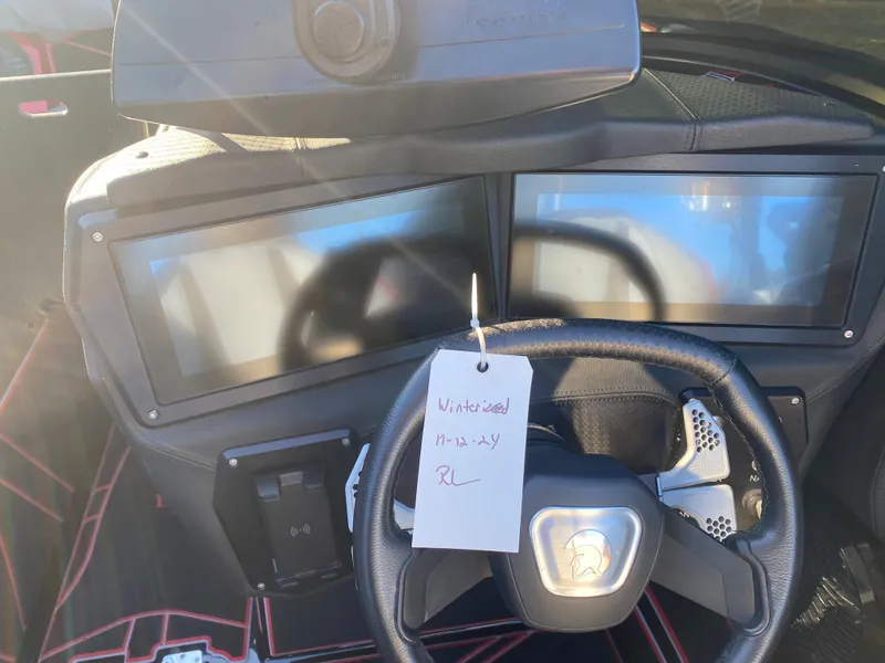 Slide: The Image of 2023 Centurion Fi23 dashboard with dual screens and steering wheel, note attached. - 9