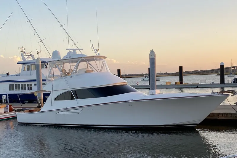 Slide: The Image of 2017 Viking 55 Convertible yacht docked at sunset. - 0