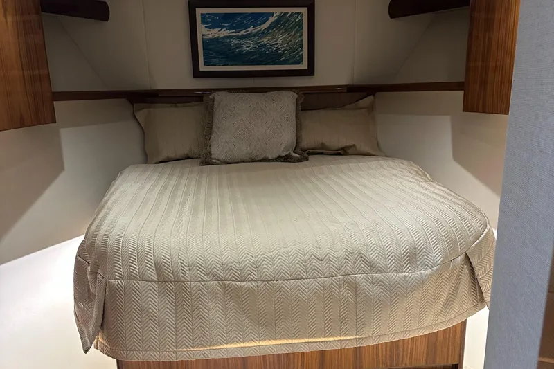 Slide: The Image of Interior cabin of 2017 Viking 55 Convertible yacht with cozy bed and ocean artwork. - 13
