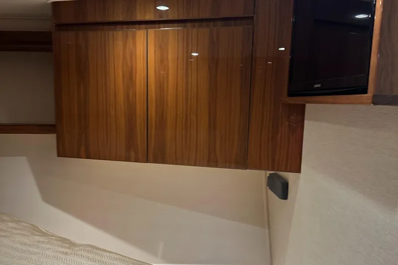 Slide: The Image of Interior of 2017 Viking 55 Convertible yacht with wooden cabinetry and mounted TV. - 14