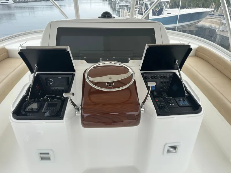 Slide: The Image of 2017 Viking 55 Convertible yacht helm with advanced controls and navigation systems. - 19