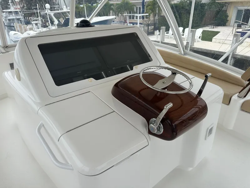 Slide: The Image of Cockpit of 2017 Viking 55 Convertible yacht with steering wheel and control panel. - 20
