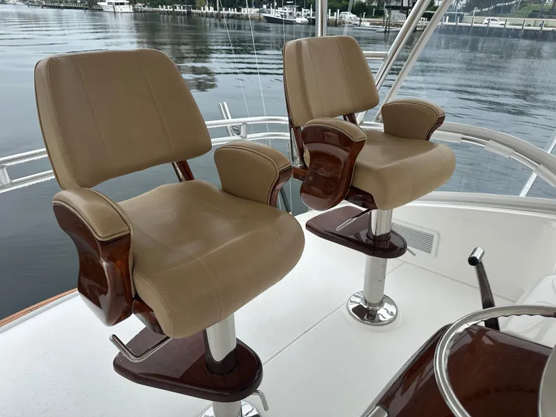 Slide: The Image of Two beige captain chairs on a 2017 Viking 55 Convertible yacht. - 21