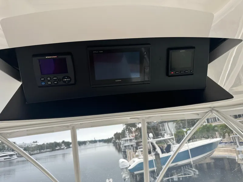 Slide: The Image of Control panel of 2017 Viking 55 Convertible yacht with navigation displays. - 22