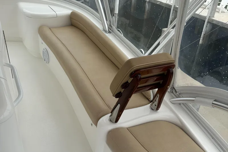 Slide: The Image of 2017 Viking 55 Convertible yacht interior with beige seating and wooden accents. - 24