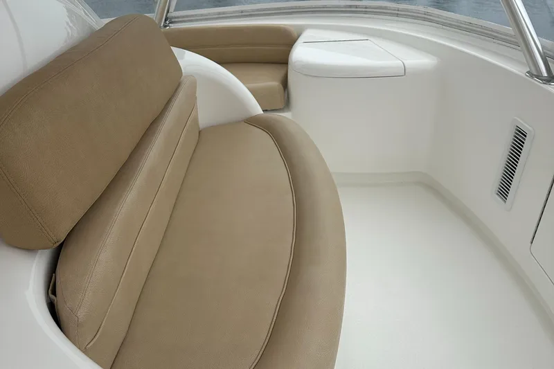 Slide: The Image of 2017 Viking 55 Convertible boat interior with beige seating and white accents. - 25