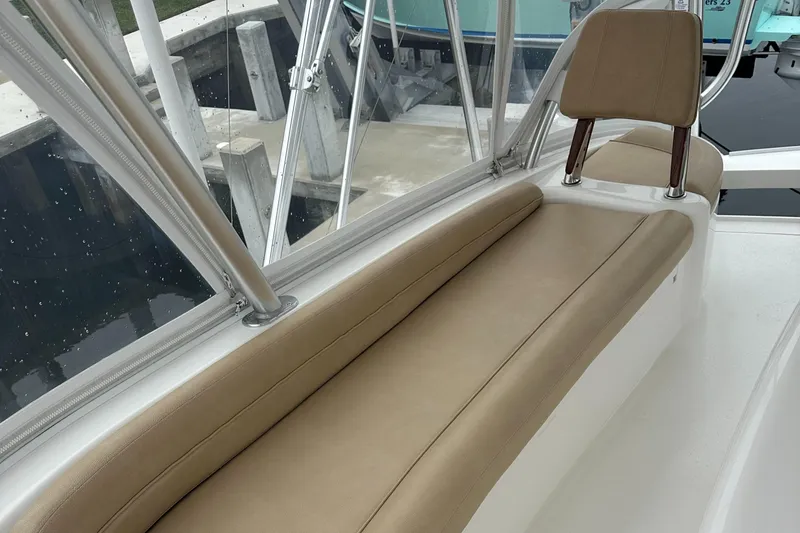 Slide: The Image of 2017 Viking 55 Convertible boat seating area with beige cushions. - 26