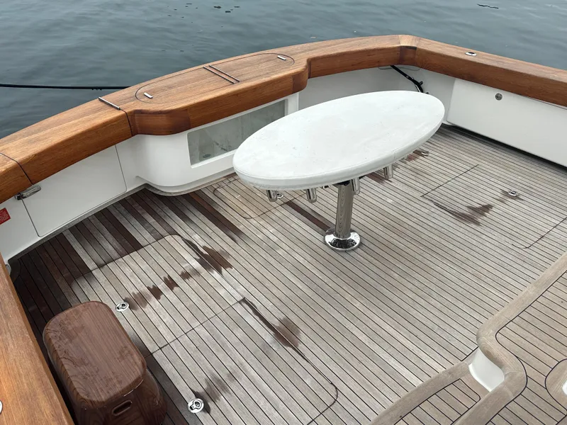 Slide: The Image of 2017 Viking 55 Convertible yacht deck with wooden flooring and oval table. - 28