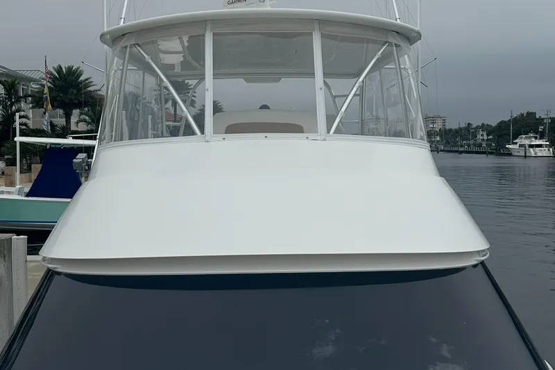 Slide: The Image of 2017 Viking 55 Convertible yacht docked by the waterfront. - 30