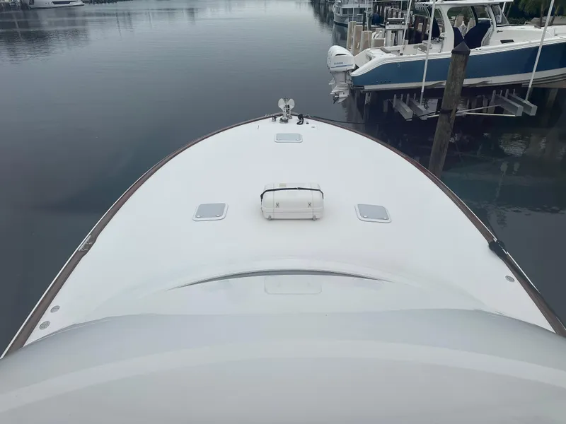 Slide: The Image of 2017 Viking 55 Convertible yacht bow view at marina. - 31