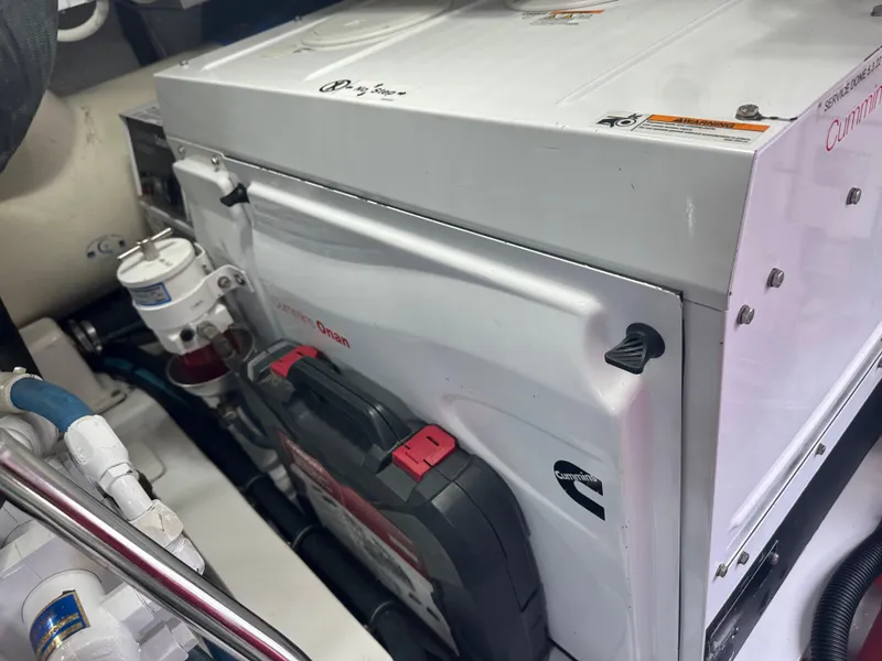 Slide: The Image of Engine room of 2017 Viking 55 Convertible yacht, featuring Onan generator and components. - 33
